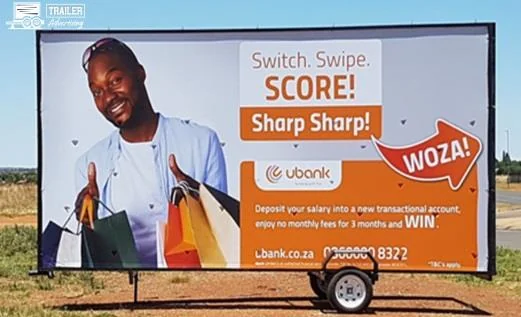 A static advertising billboard mounted on a road trailer